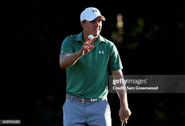 Jordan Spieth holds up his ball after finishing round one of the Hyundai Tournament of Champions at the Plantation Course at Kapalua Golf Club on...