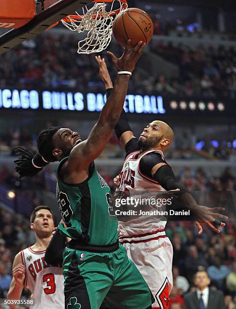 Jae Crowder of the Boston Celtics puts up a shot against Taj Gibson of the Chicago Bulls at the United Center on January 7, 2016 in Chicago,...