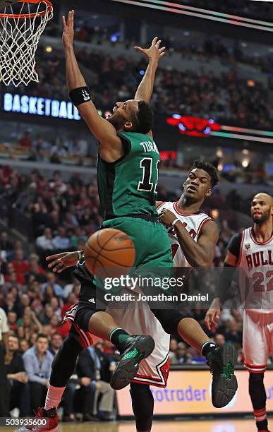 Evan Turner of the Boston Celtics looses control of the ball after it was knocked away by Jimmy Butler of the Chicago Bulls at the United Center on...