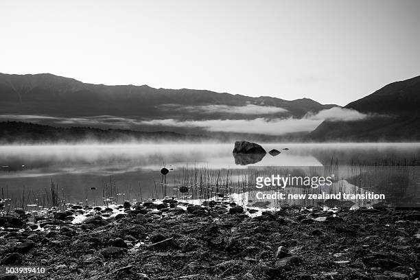 black and white morning mist on lake rotoiti, nelson lakes national park, new zealand - nelson lakes national park stock pictures, royalty-free photos & images