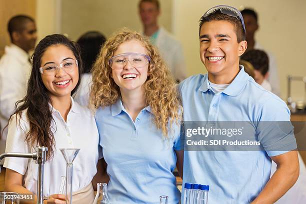 high school students smiling in science chemistry lab - teenagers only stock pictures, royalty-free photos & images