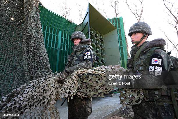 South Korean soldiers drow down a cover from the loudspeakers at a military base near the border between South Korea and North Korea on January 8,...