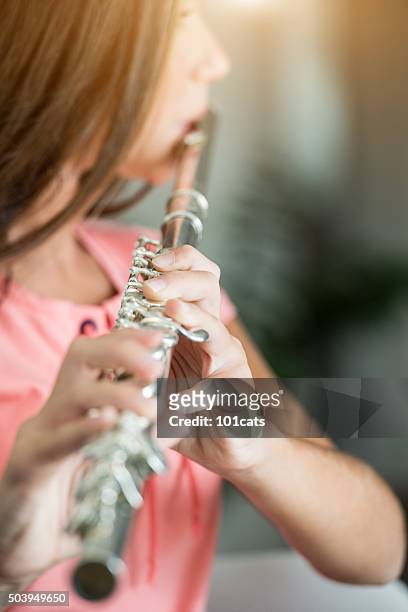 teenage girl plays the flute - musikinstrument bildbanksfoton och bilder