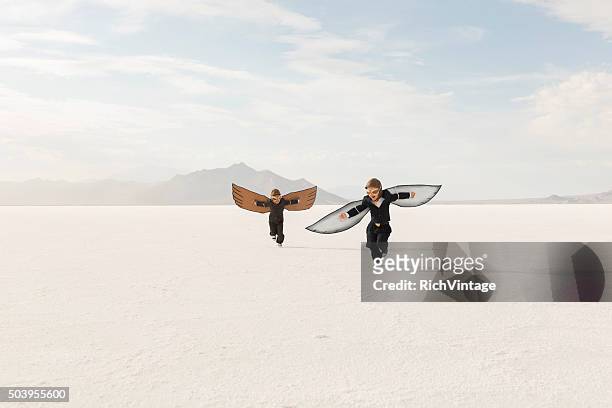 young business boys wearing cardboard wings are flying - sayings stockfoto's en -beelden