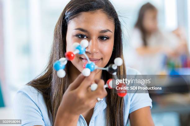 hispanic high school student studying molecule model in science class - chemistry model stock pictures, royalty-free photos & images