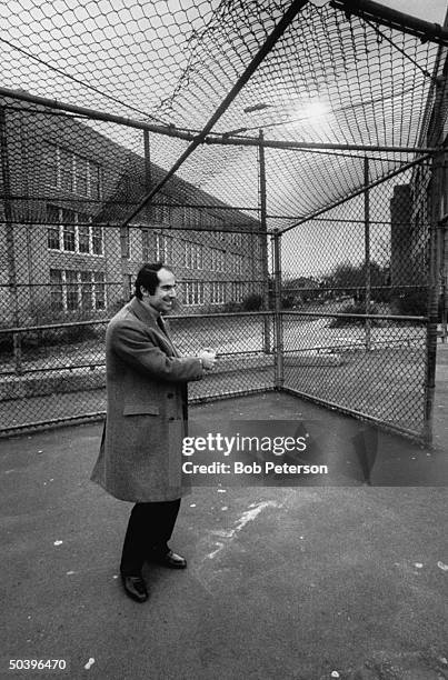 Author, Philip Roth, revisiting areas where he grew up in Newark, probably in school yard where he attended school.