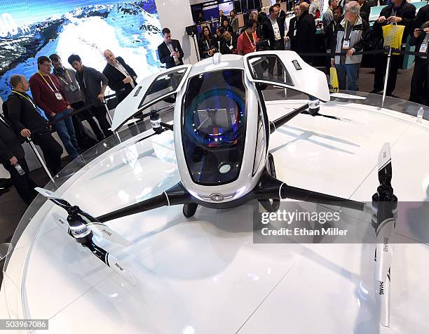 Attendees look at an EHang 184 autonomous-flight drone that can fly a person at CES 2016 at the Las Vegas Convention Center on January 7, 2016 in Las...
