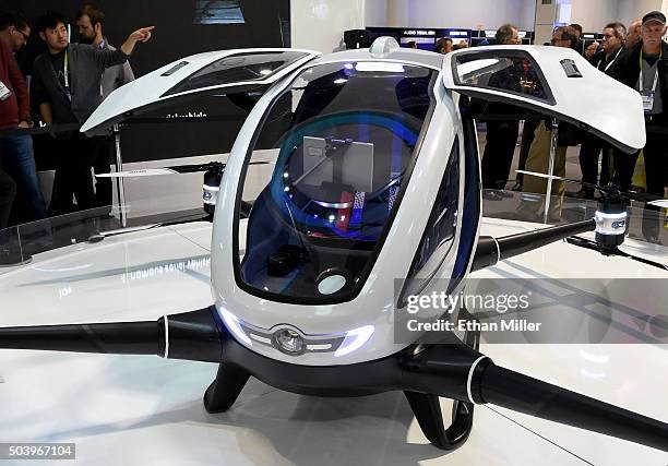 Attendees look at an EHang 184 autonomous-flight drone that can fly a person at CES 2016 at the Las Vegas Convention Center on January 7, 2016 in Las...