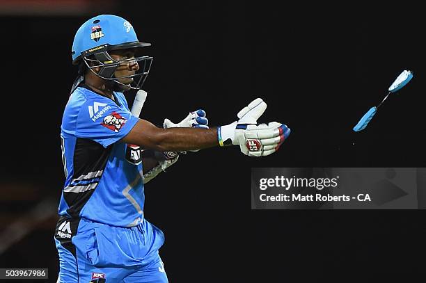 Mahela Jayawardena of the Strikers throws part of his helmet to an umpire after being stuck by the ball while batting during the Big Bash League...