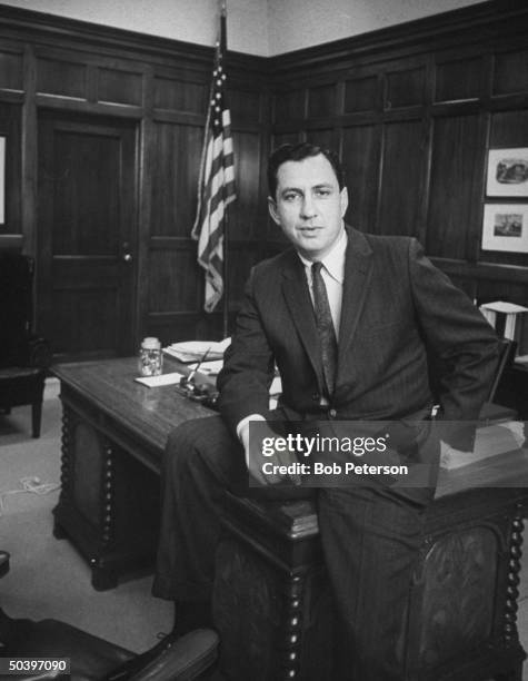 Philadelphia District Attorney, Arlen Specter, ex-staff member of Warren Commission, sitting on desk in his office.