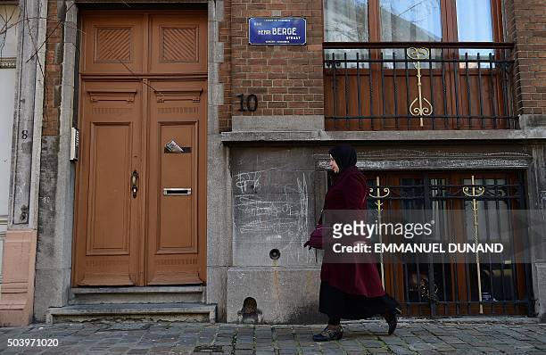 Woman walks past a sign indicating Rue Henri Berge in the Brussels district of Schaerbeek, on January 8, 2016 in Brussels. Belgian police have found...