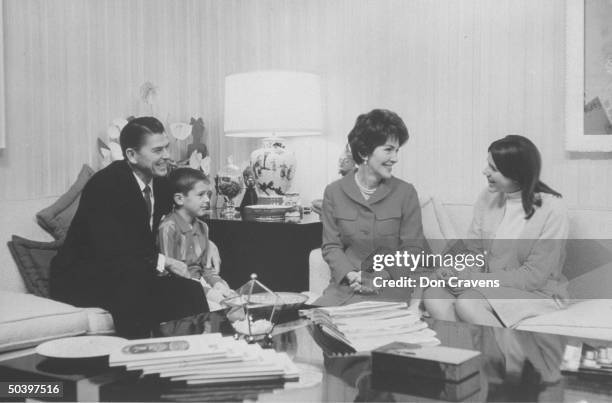 Actor and politico, Ronald W. Reagan, sitting at home with wife and two children.