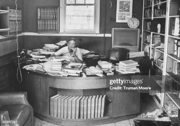 New York City, mayoral candidate, William F. Buckley Jr., also editor of Conservative National Review talking on the phone at home in his study.