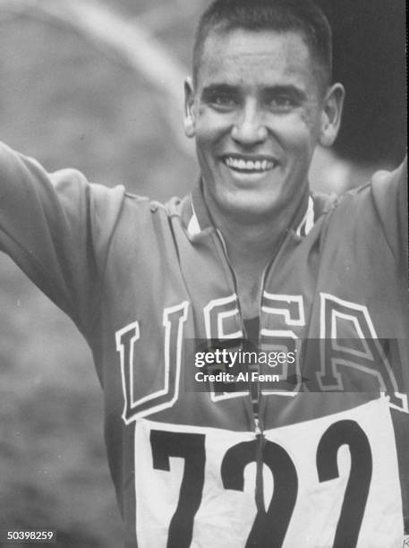 American Billy Mills celebrating winning the gold medal in the 10,000 meter race at the Summer Olympics.