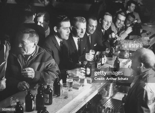 Empire Hotel bar crowded with prospectors, celebrating claim during copper and silver strike.