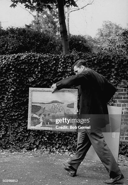 Man with a paingint by Anna M. Moses, which he bought at the Helen Hayes auction