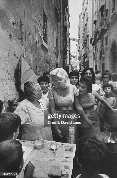 Singer Juli Reding walking down the street visiting with fans during her visit.