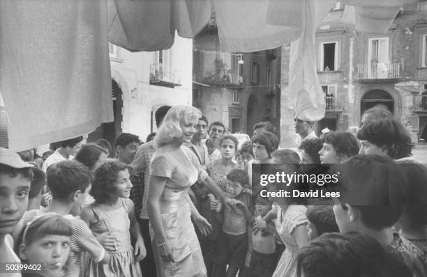 Singer Juli Reding being greeted by a group of young fans during her visit.