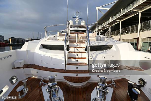 Stairs lead up to a higher desk on-board a 131 yacht, manufactured by Sunseeker International Ltd., on display at the 2016 London Boat Show at the...