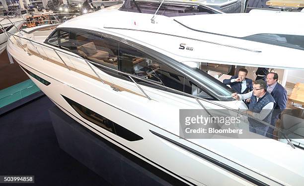 Visitors stand on board a Princess S65 boat on display at the 2016 London Boat Show at the ExCel exhibition centre in London, U.K., on Friday, Jan....