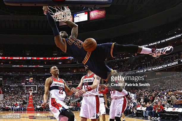 LeBron James of the Cleveland Cavaliers dunks in front of Otto Porter Jr. #22 of the Washington Wizards and teammates during the second half at...