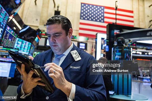 Trader works on the floor of the New York Stock Exchange during the morning of January 8, 2016 in New York City. U.S. Markets have declined over the...