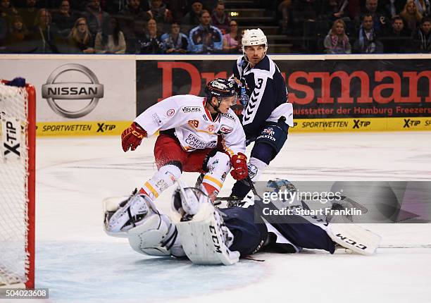 Sébastien Caron of Hamburg saves a shot fromAlexander Preibisch of Duesseldorf during the DEL ice hockey match bewteen Hamburg Freezers and...