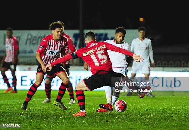Jerome Sinclair of Liverpool beats Jordan Moore-Taylor of Exeter City to score their first and equalising goal during the Emirates FA Cup third round...