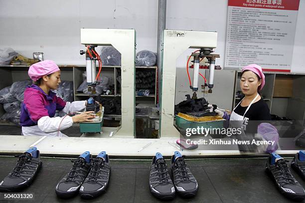PUTIAN, 8, 2016 -- Workers make shoes for export at an OEM