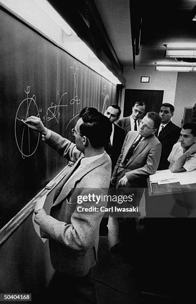 Scientist Roger Gallet of the National Bureau of Standards Boulder Laboratory charting path of Sputnik I