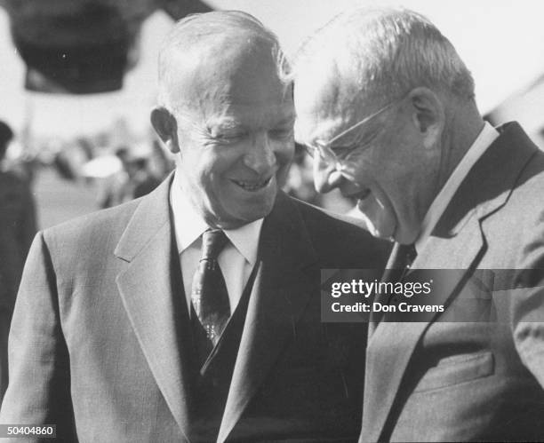 President Dwight D. Eisenhower speaking w. John Foster Dulles at National aiport.