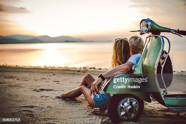 couple on the beach with retro bike - vintage motorcycle stock pictures, royalty-free photos & images