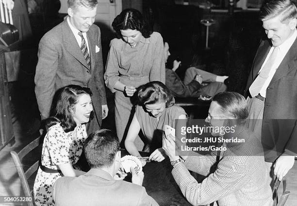 Alpha Delta Phi, Fraternities, Student Life Candid shot of fraternity members and their girlfriends laughing and playing cards, 1947. .