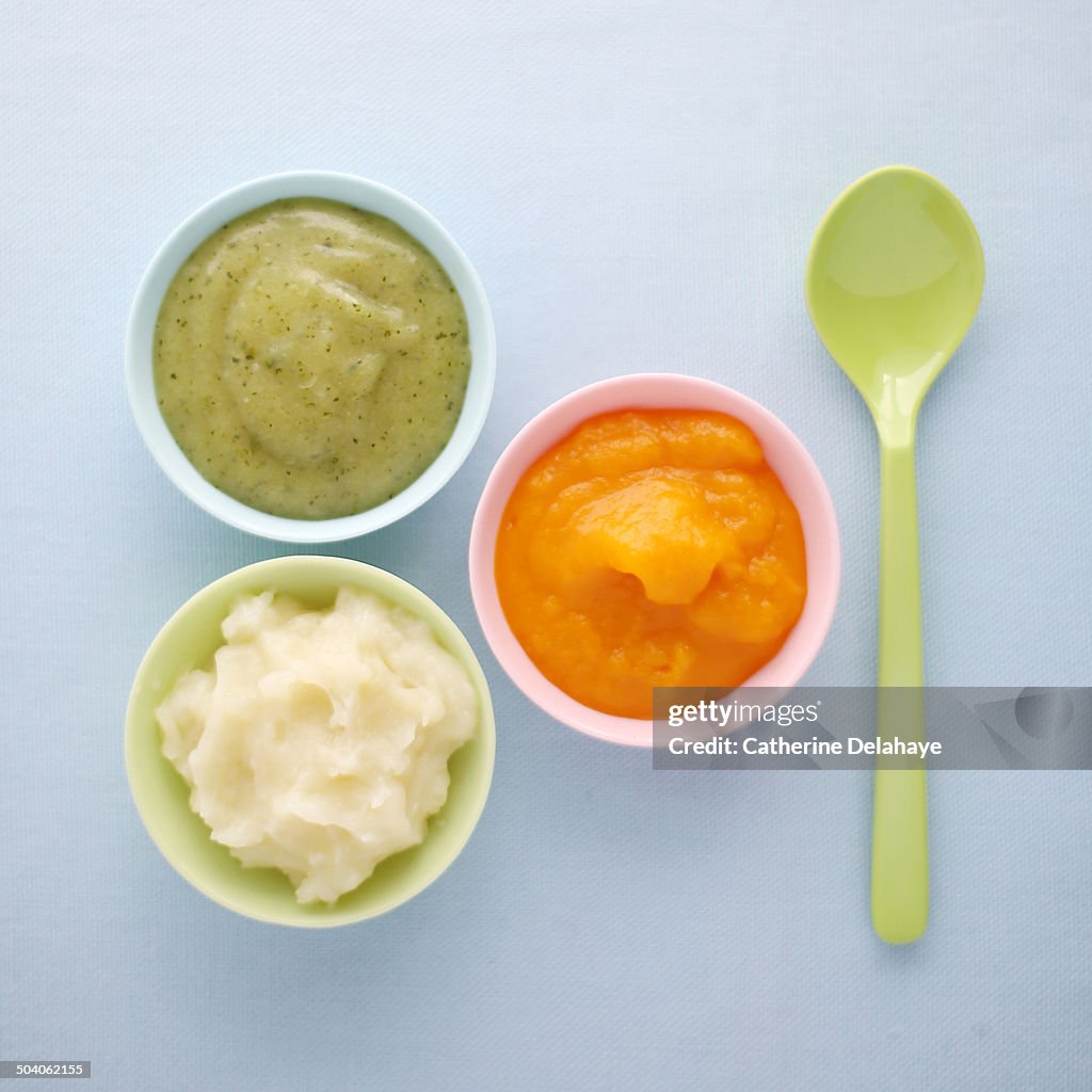 Close-up of vegetables mashes in baby bowls