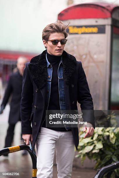 Oliver Cheshire enters the Topman show during The London Collections Men AW16 on January 8, 2016 in London, England. Oliver wears a navy peacoat with...