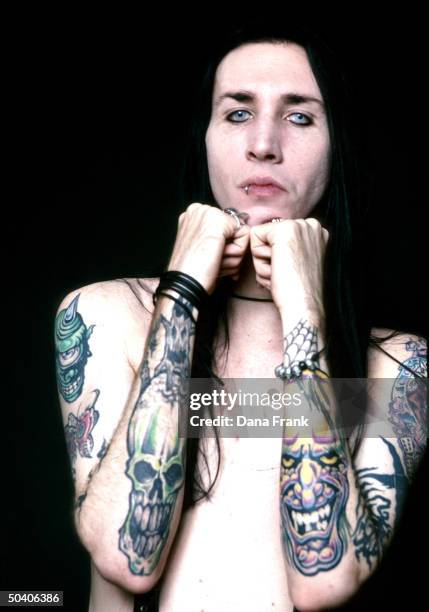 Shock-rocker Marilyn Manson w. Tattooed arms.