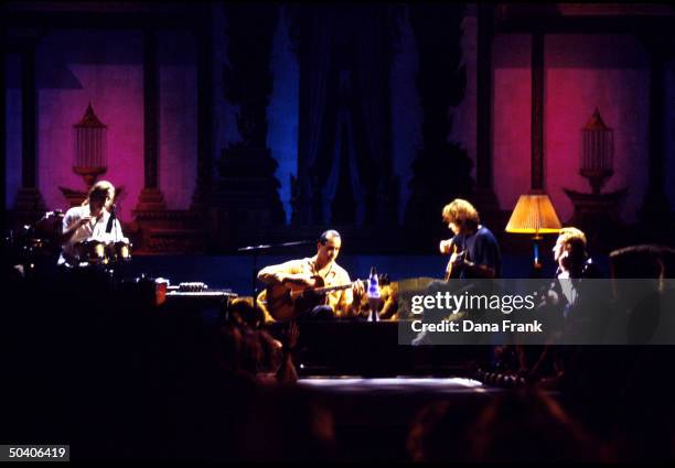 Rock group Stone Temple Pilots performing on living room set.