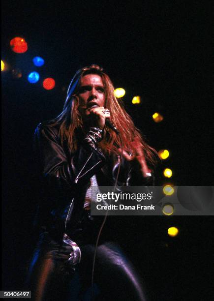 Lead singer of heavy metal band Skid Row, Sebastian Bach, singing onstage.