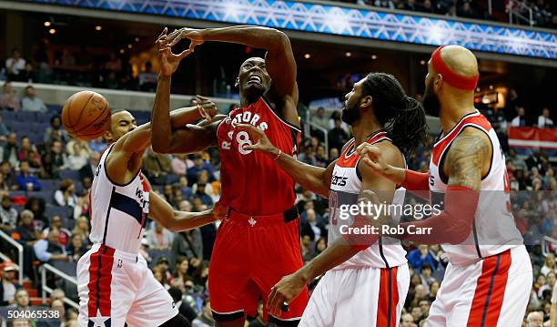 Bismack Biyombo of the Toronto Raptors is fouled by Ramon Sessions of the Washington Wizards in the first half at Verizon Center on January 8, 2016...