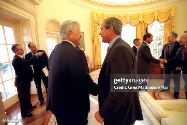 President George W. Bush talking w. Sen. Ted Kennedy at joint congressional coffee meeting on education in the Oval Office of the White House.