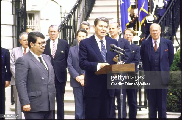 President Ronald W. Reagan with Turkish Prime Minister Turgut Ozal during departure ceremony with State Secretary George P. Shultz, unidentified,...