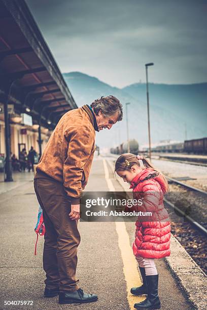 grandfather and girl in pink enjoying the railway station, europe - slovenia winter stock pictures, royalty-free photos & images