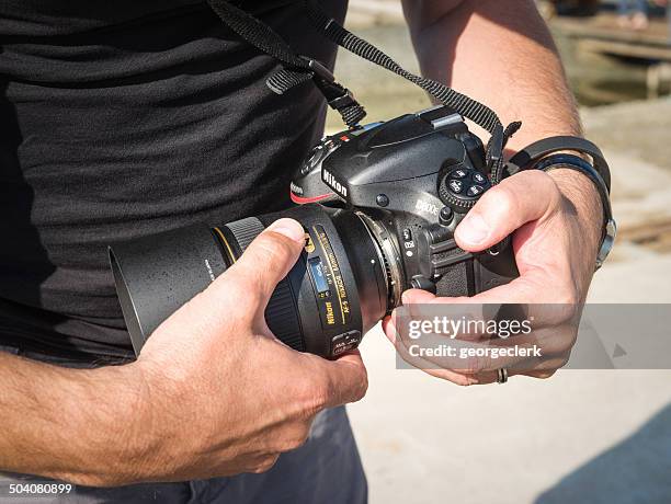 photographer changing lens - nikon stock pictures, royalty-free photos & images