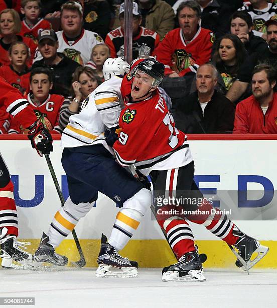 Jonathan Toews of the Chicago Blackhawks collides with Evander Kane of the Buffalo Sabres at the United Center on January 8, 2016 in Chicago,...