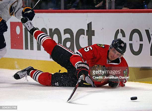Artem Anisimov of the Chicago Blackhawks hits the ice while chasing the puck against the Buffalo Sabres at the United Center on January 8, 2016 in...