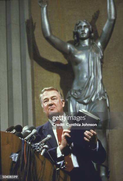 Attorney General Edwin Meese holding report from the Commission on Pornography.