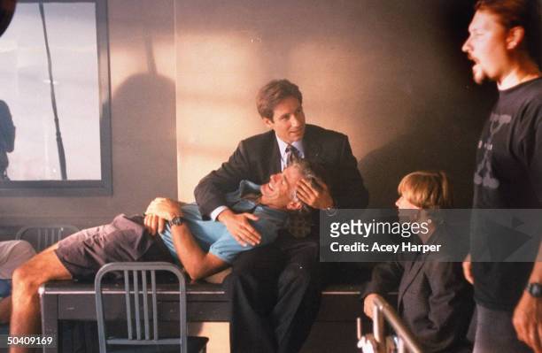 David Duchovny, co-star of cult hit TV series The X-Files, chatting w. Unident. Man & woman while jokingly holding the head of Chris Carter, the...