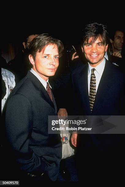 Actor Michael J. Fox chatting w. White House sr. Advisor George Stephanopoulos at bash for NEWSWEEK magazine.