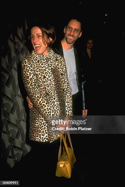Actress Frances McDormand wearing leopard print coat while sharing laugh w. Dir. Husband Joel Coen at NY Film Critics Circle Awards.