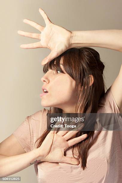 woman with hands and face pressed against glass - translucent glass stock pictures, royalty-free photos & images